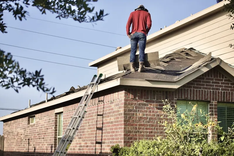 Professional roofer working on a residential roof in North Andover Center